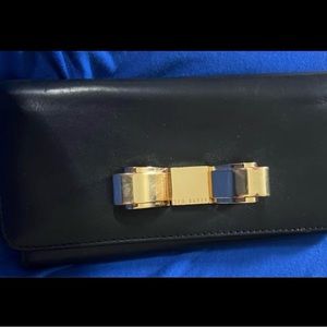 Beautiful black soft leather Ted Baker clutch wallet with signature gold bow.